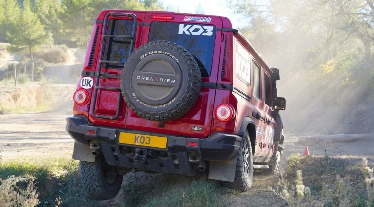 Ineos Grenadier with a wheel in the air.