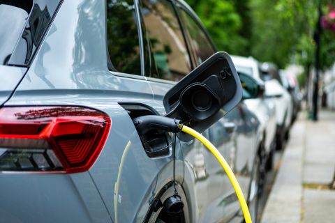 An electric car plugged in on charge on a residential street in central London