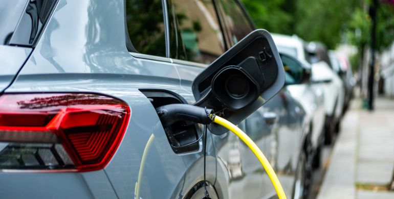 An electric car plugged in on charge on a residential street in central London