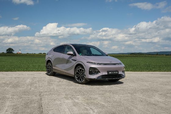 XPENG G6 next to a field