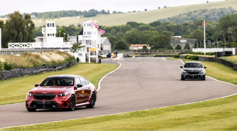 Two BMW M5s at Goodwood race track.