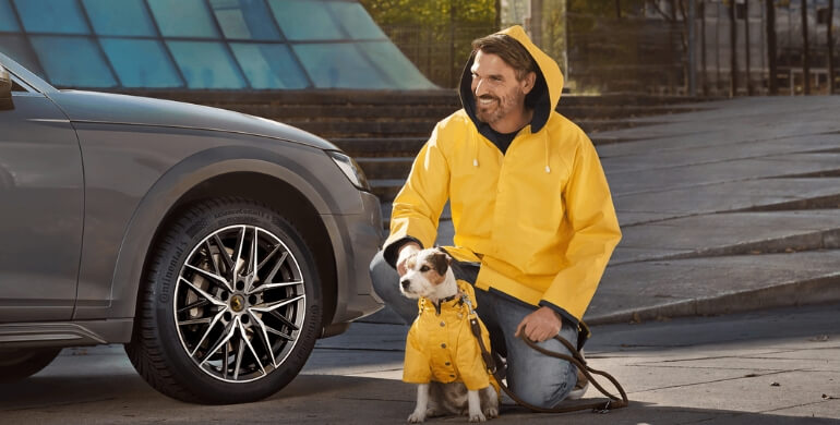 Continental rain jackets on man and dog