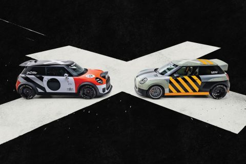 Two customised Mini JCWs parked facing each other with Deus Ex Machine branding