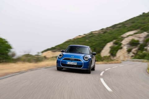 Blue mini cooper on road