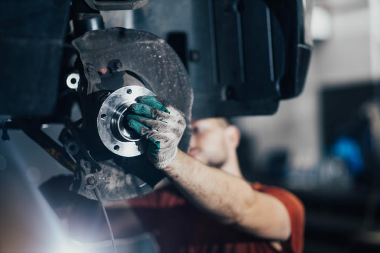 A garage specialist replacing a wheel