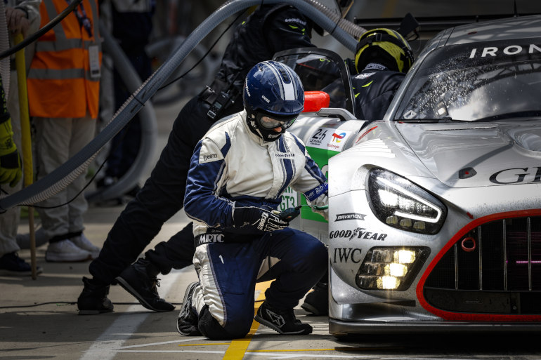Man changing tyre on a racing car
