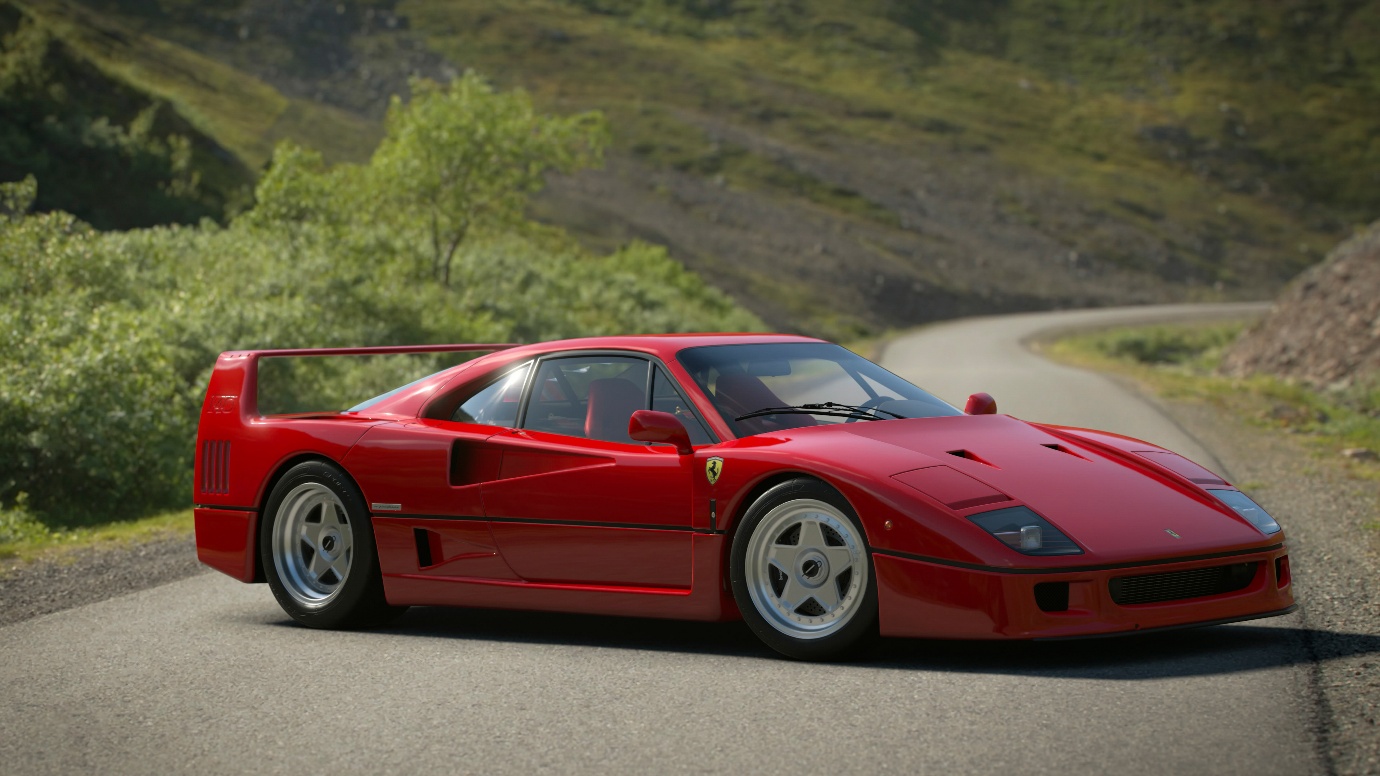 Red Ferrari F40 parked on a winding country road