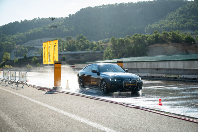 Black BMW braking on a wet test surface at Continental’s Born to Outperform event