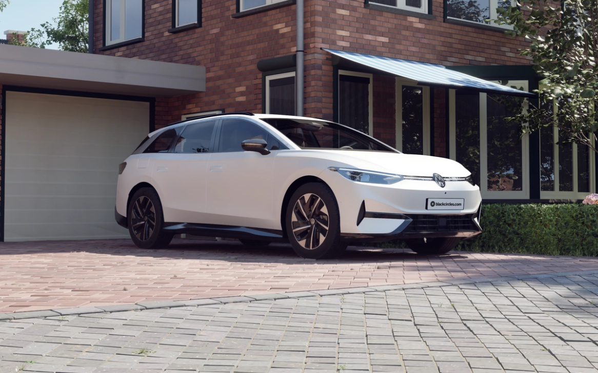 White Volkswagen ID.7 GTX estate parked on a driveway outside a brick house