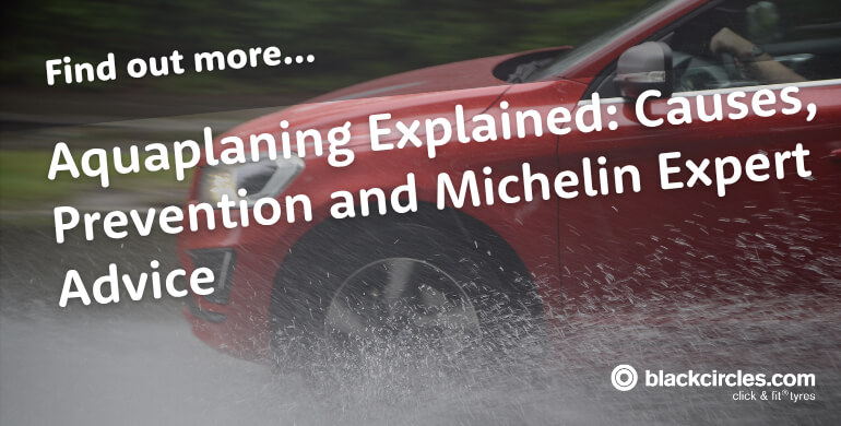 Car driving through standing water in heavy rain