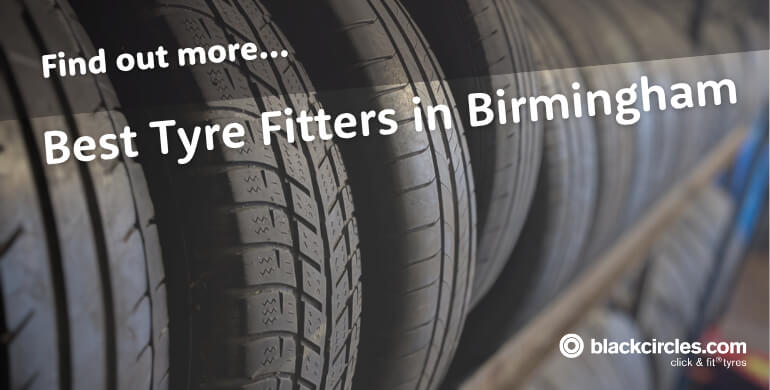 Tyre being fitted to a car wheel