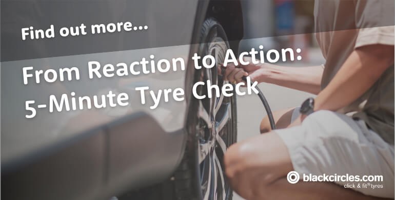 Driver checking tyre pressure with a gauge