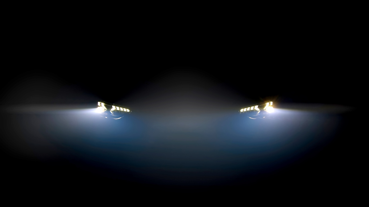 Car headlights glowing in the dark at night