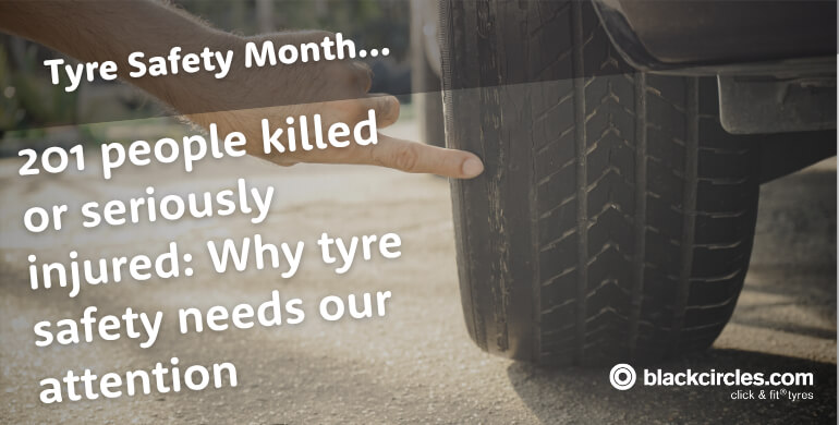 A finger pointing at the worn tread of a car tyre for Tyre Safety Month