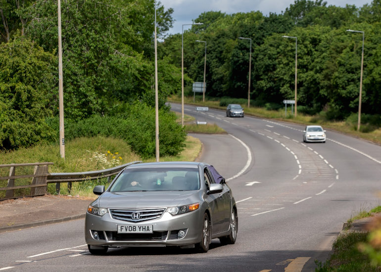 Silver Honda Accord driving on UK road
