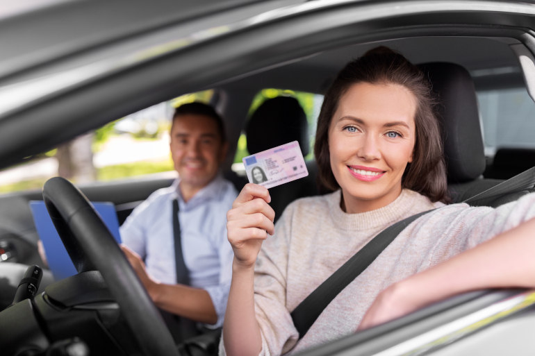 Woman presenting driving licence in a car