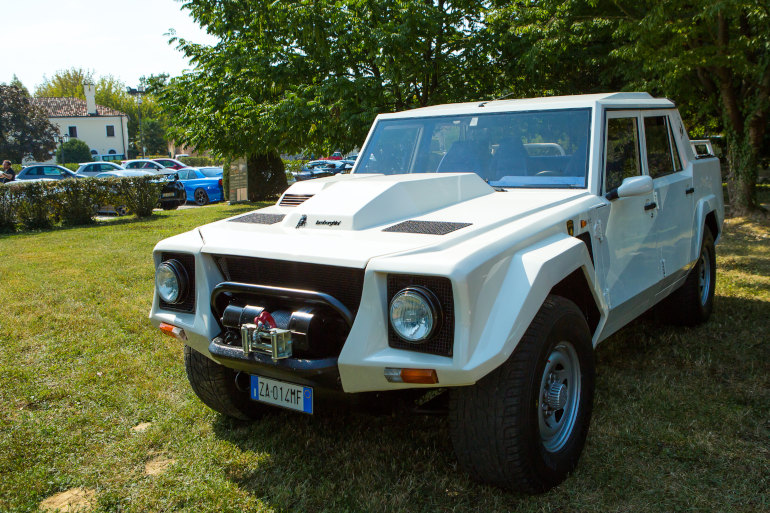 Grey car driving on a mountain road