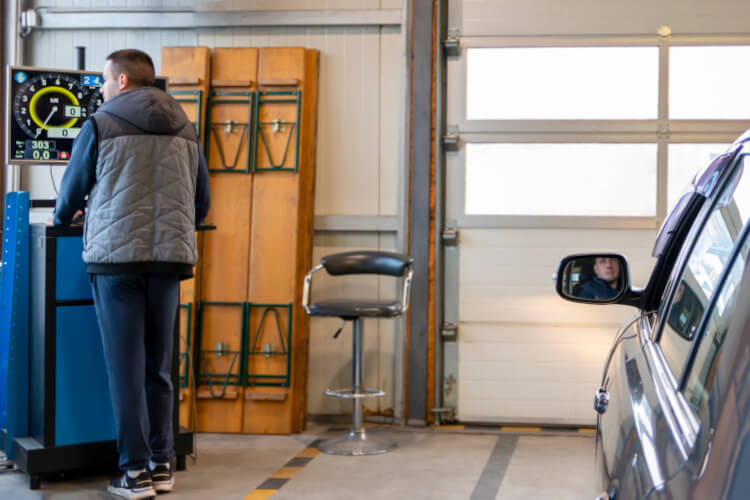 MOT testers testing a car